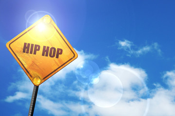 Yellow road sign with a blue sky and white clouds: hip hop music