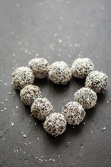 Homemade Healthy Paleo Raw Chocolate Truffles with Nuts, Dates and Coconut Flakes Arranged in Heart Shape