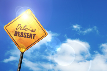 Yellow road sign with a blue sky and white clouds: Delicious des