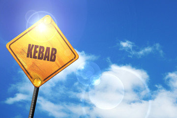 Yellow road sign with a blue sky and white clouds: Delicious keb