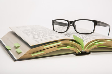 Study, book with post it's and reading glasses