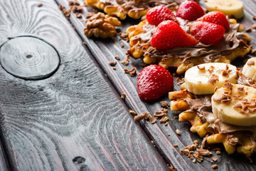 strawberries and bananas on wafers with chocolate paste