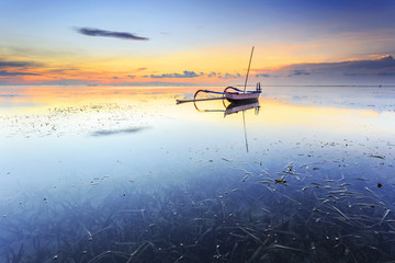 Balinese jukung fishermen with beautiful sunrise in Bali, Indonesia
