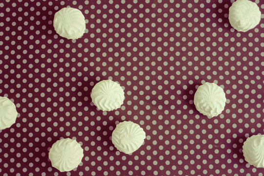 Top view of Latvian marshmallovs - zefiri on purple polka dot background, vintage filter