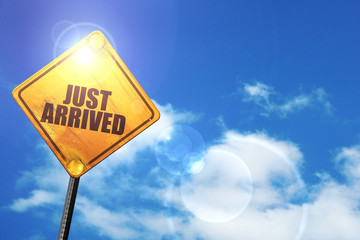Yellow road sign with a blue sky and white clouds: just arrived