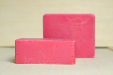 Soap bar flavor with strawberry ingredient isolated on wooden bo
