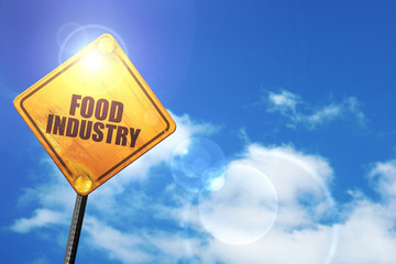 Yellow road sign with a blue sky and white clouds: food industry