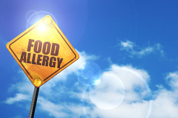 Yellow road sign with a blue sky and white clouds: food allergy