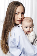 Beautiful mother holding son, portrait