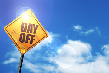 Yellow road sign with a blue sky and white clouds: day off