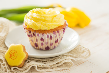 Vanilla cupcakes on white wood background
