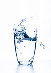 water splashing from glass isolated on white background