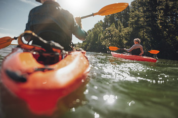Mature woman kayaking in lake on a sunny day