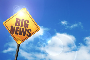 Yellow road sign with a blue sky and white clouds: big news