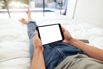 Man holding a blank digital tablet