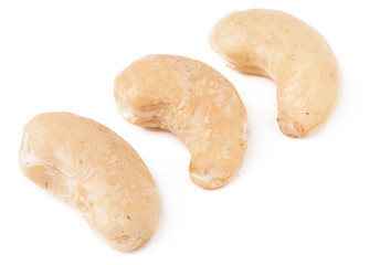 few cashew nuts on a white background close-up