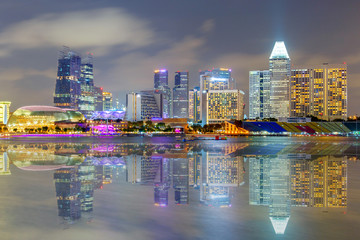 Fototapeta na wymiar Reflection Building in Singapore at night view of Marina Bay