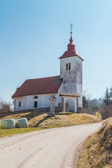 Church of St. Florian by the rural road in the rays of spring sun, Slovenia.