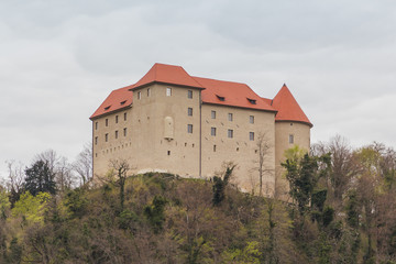 Fototapeta na wymiar Brestanica, Slovenia - April 2, 2016. View of the Rajhenburg castle on the top of the hill.