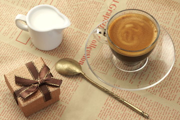 Coffee Cup With Espresso, Milk And  Gift Box On Newspaper