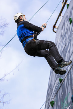 Man climbing up a wall in an exercise for mountaineering