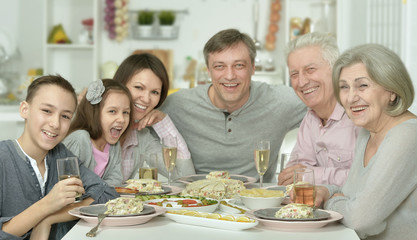 family at the table with tasty food