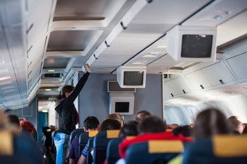 Naklejka premium Interior inside of the plane with passengers.