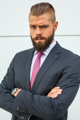 Portrait of a young focused businessman outside the office build