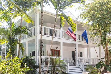 American Flag on White Wood House with Two Verandas