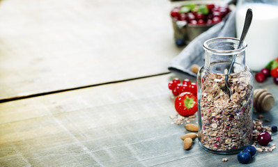 Obraz na płótnie Canvas Close up of jar with granola or muesli on table