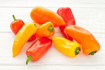 Colorful mini paprika on a white wooden table