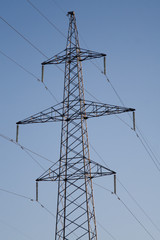 Electric power station lines, on the blue sky backing in the sunset