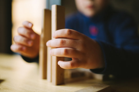 Boy Playing with a Construction Wooden Game