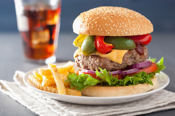 homemade cheese burger with peppers tomato onion
