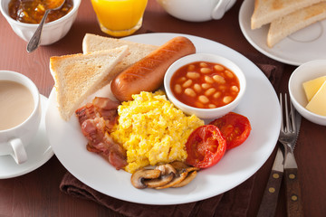 full english breakfast with scrambled eggs, bacon, sausage, bean