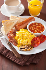full english breakfast with scrambled eggs, bacon, sausage, bean