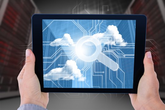 Composite image of businesswoman holding digital tablet