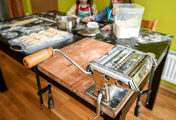 Family is making home made pastry dumplings tortellini or raviol
