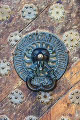 Vintage brass knob on the old wooden door