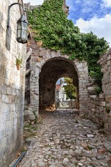 Fototapeta na wymiar Ancient arch pathway on a Bar old town in Montenegro