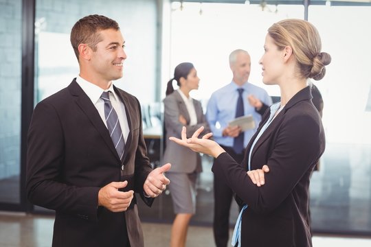 Businessman and businesswoman interacting 