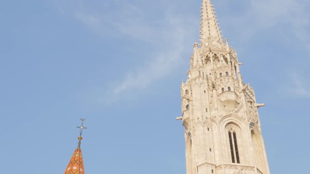 Tilting Matthias church and fountain nearby on Buda hill in Budapest 4K 2160p UltraHD footage - Matyas-templom in Budapest Hungary on Budas Castle District 4K 3840X2160 UHD tilt video
