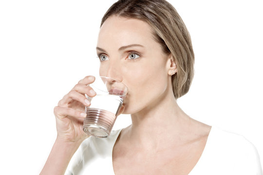 Young Caucasian woman drinking a glass of water