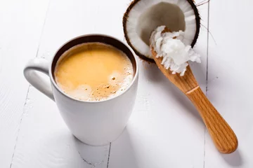 Foto auf Alu-Dibond Bulletproof coffee, it's a coffee blended with butter or coconut oil. Wiev from above on coffee and coconut. Part of ketogenic diet, better choice before trainning. © cegli