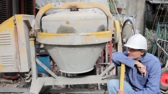 construction worker with cement mixer
