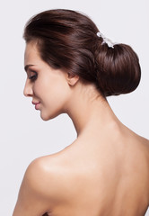 Portrait of beautiful young brunette woman from back side
