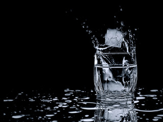 a glass of water ice drops splashes freshness thirst
