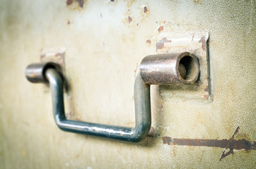 Selective focus and close up / Steel handle on old steel door