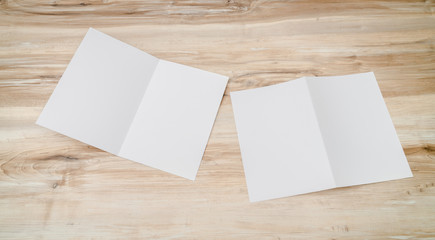 Bifold white template paper on wood texture