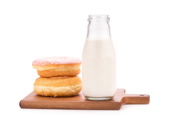 Milk bottle and donut on white background